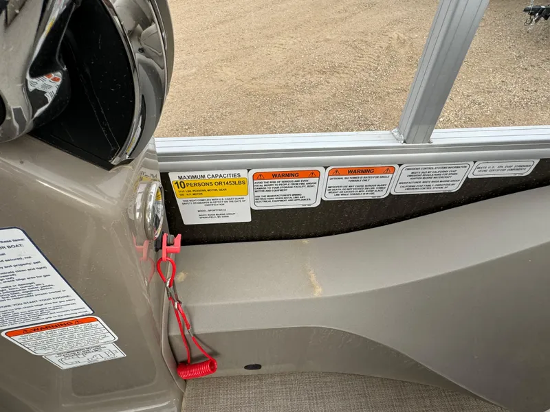 Slide: The Image of 2023 Sun Tracker SportFish 22 DLX interior with safety warnings and capacity label. - 14