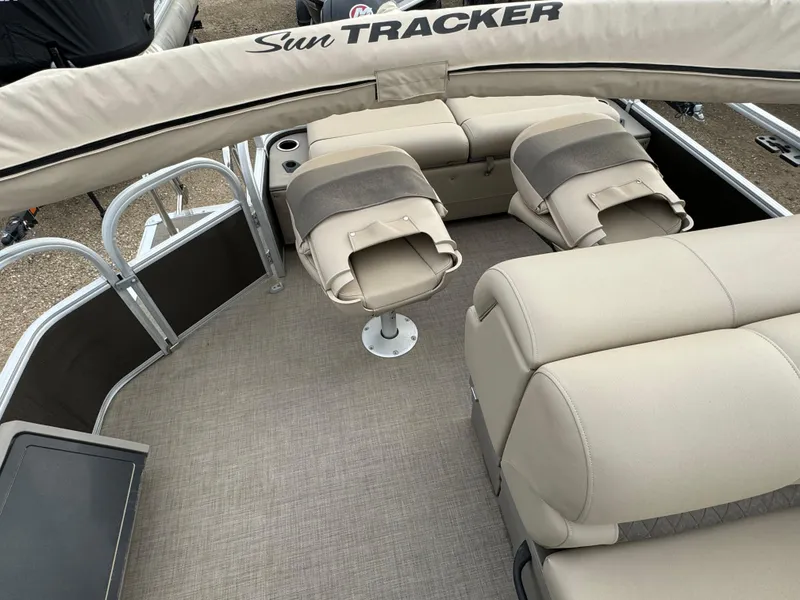 Slide: The Image of 2023 Sun Tracker SportFish 22 DLX interior with beige seating and fishing chairs. - 16