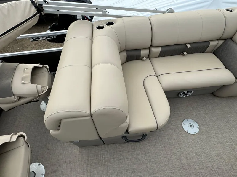Slide: The Image of 2023 Sun Tracker SportFish 22 DLX interior with beige seating and cup holders. - 17