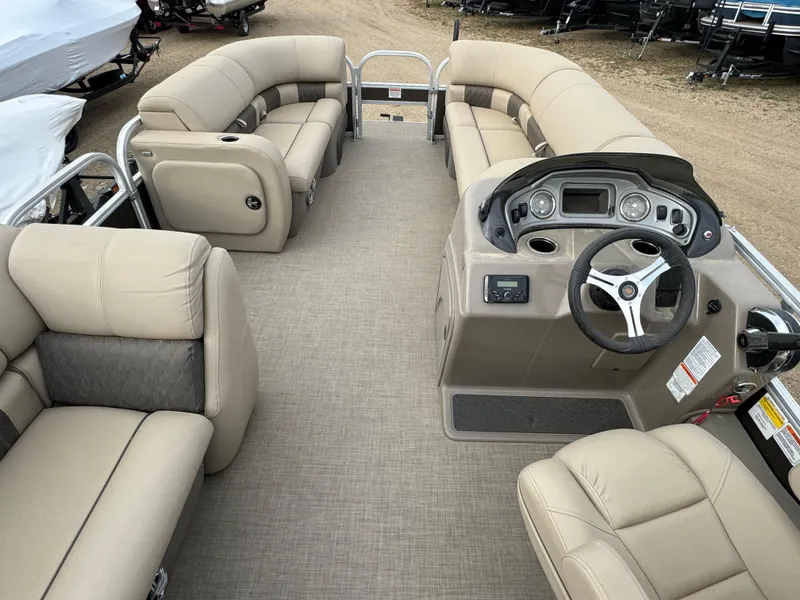 Slide: The Image of 2023 Sun Tracker SportFish 22 DLX pontoon boat interior with beige seating and steering console. - 18