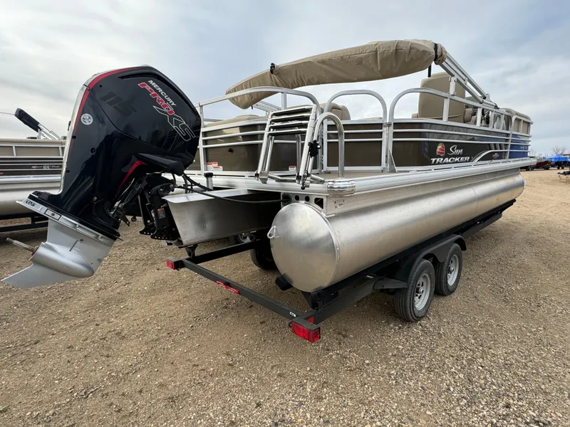 Slide: The Image of 2023 Sun Tracker SportFish 22 DLX pontoon boat with outboard motor on trailer. - 3
