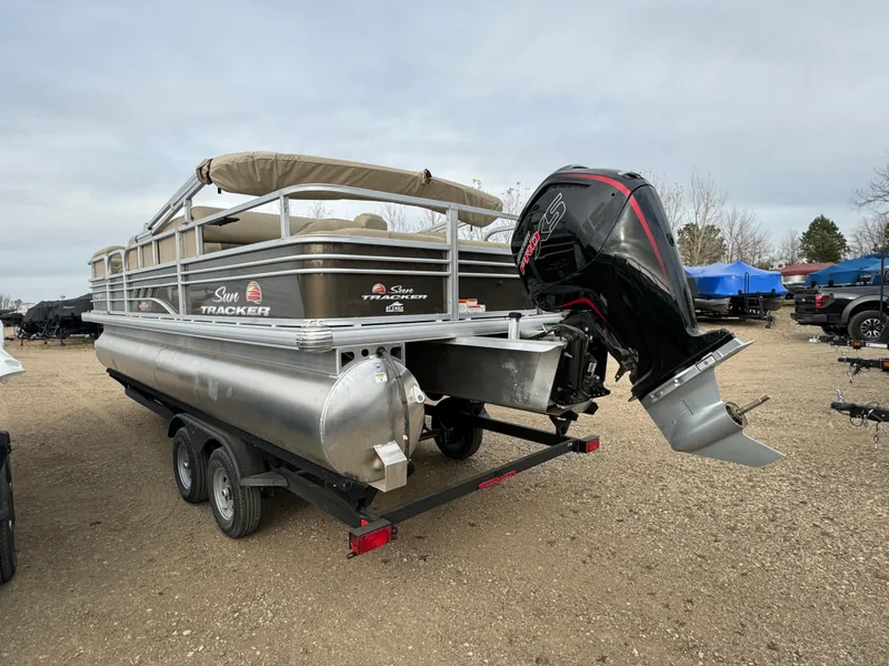 Slide: The Image of 2023 Sun Tracker SportFish 22 DLX pontoon boat with outboard motor on trailer. - 4