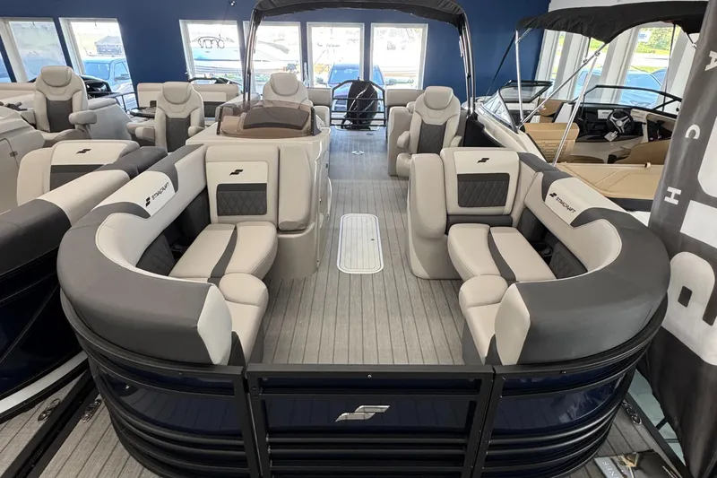 The Image of 2025 Starcraft SLS 3 pontoon boat with luxurious seating and modern design in a showroom. - 0