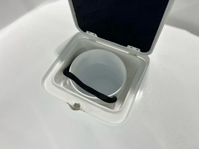 Slide: The Image of 2025 Tidewater 2300 Carolina Bay storage compartment with open lid and rope handle. - 12