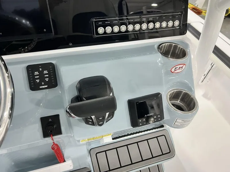 Slide: The Image of 2025 Tidewater 2300 Carolina Bay boat console with controls and cup holders. - 22