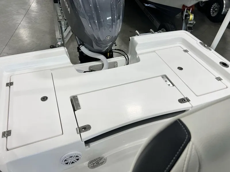 Slide: The Image of 2025 Tidewater 2300 Carolina Bay boat deck with storage compartments and motor. - 28