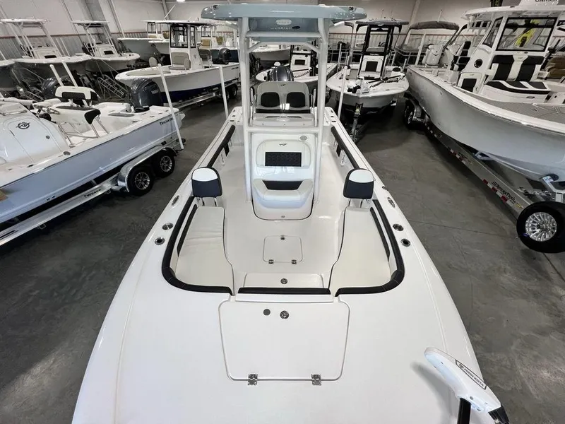 Slide: The Image of 2025 Tidewater 2300 Carolina Bay boat in showroom, surrounded by other boats. - 33
