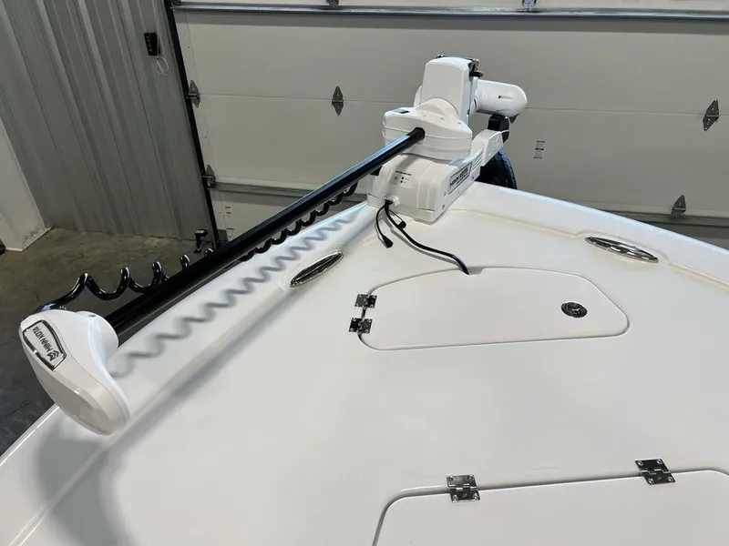 Slide: The Image of 2025 Tidewater 2300 Carolina Bay boat with trolling motor in garage. - 4