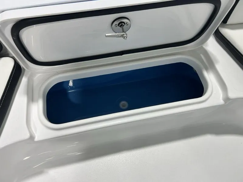 Slide: The Image of 2025 Tidewater 2300 Carolina Bay boat storage compartment with blue interior. - 9