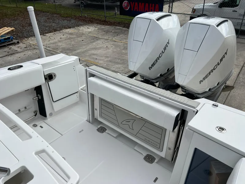 Slide: The Image of 2025 Blackfin 272 CC boat with dual Mercury engines, white deck, and storage compartments. - 14