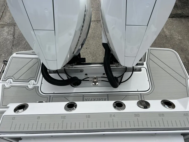 Slide: The Image of 2025 Blackfin 272 CC boat with dual outboard motors and fishing rod holders. - 15