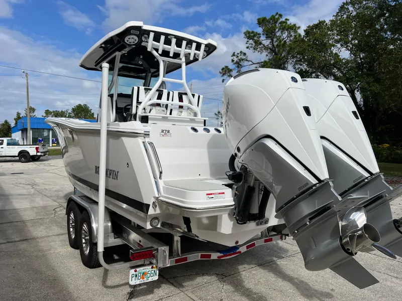Slide: The Image of 2025 Blackfin 272 CC boat with dual engines on a trailer. - 26