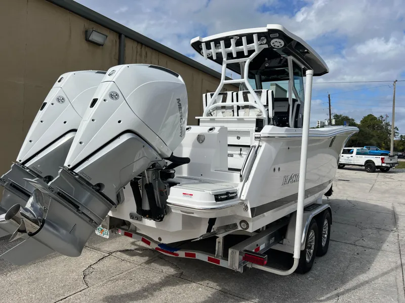 Slide: The Image of 2025 Blackfin 272 CC boat with dual engines on a trailer. - 29