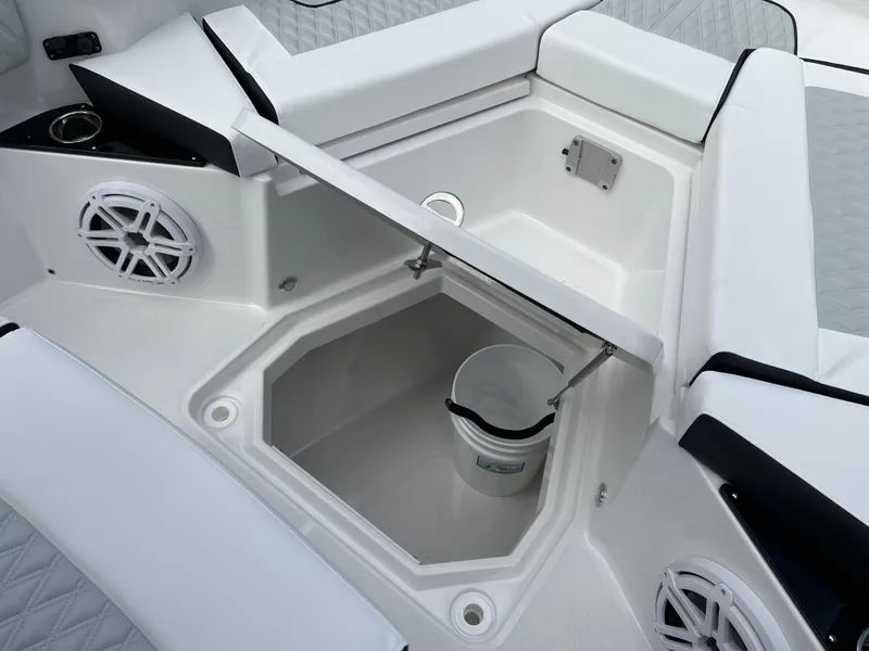 Slide: The Image of 2025 Blackfin 272 CC boat interior with storage compartment and speakers. - 3
