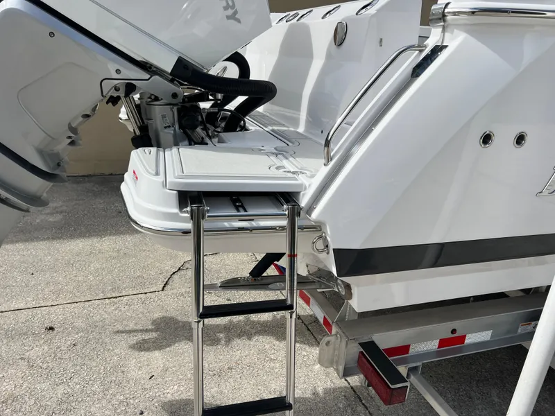 Slide: The Image of 2025 Blackfin 272 CC boat with ladder and outboard motor on trailer. - 31