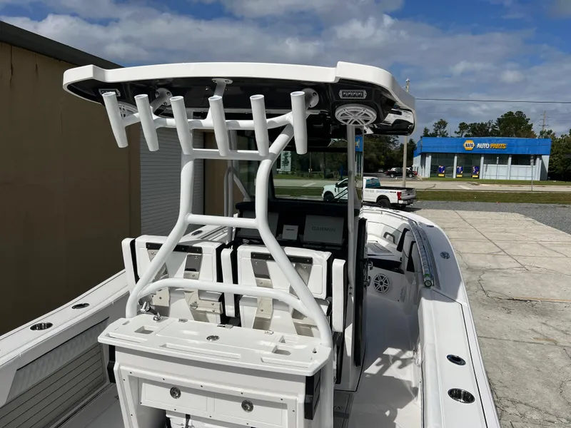 Slide: The Image of 2025 Blackfin 272 CC boat with T-top and rod holders, docked outdoors. - 33