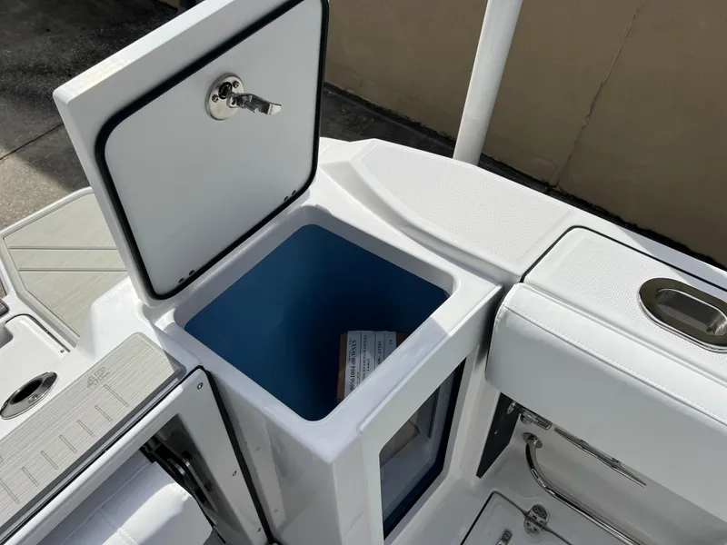 Slide: The Image of 2025 Blackfin 272 CC boat storage compartment with open lid. - 38