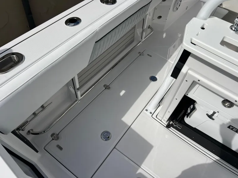 Slide: The Image of 2025 Blackfin 272 CC boat interior with sleek white deck and storage compartments. - 39