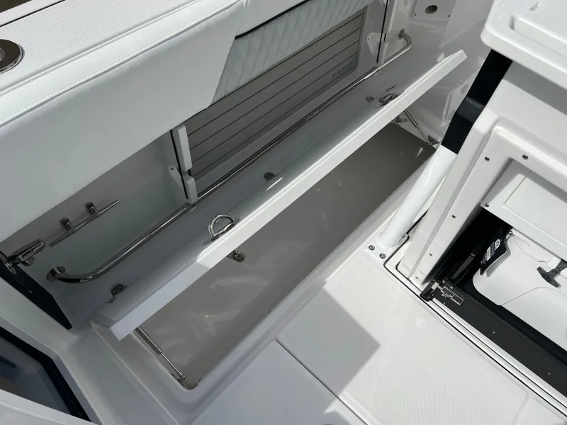 Slide: The Image of 2025 Blackfin 272 CC boat storage compartment with sleek white interior design. - 40