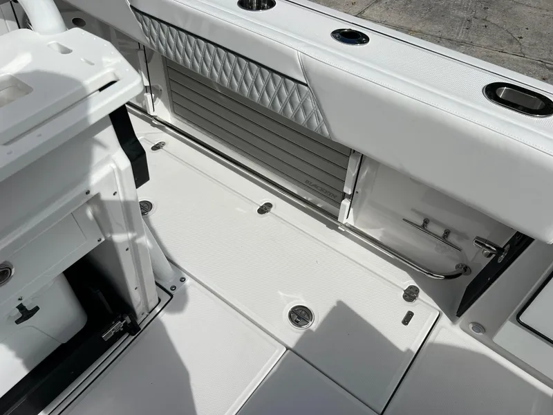 Slide: The Image of 2025 Blackfin 272 CC boat interior with white seating and storage compartments. - 41