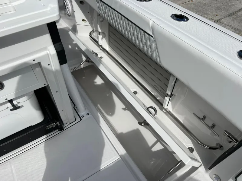 Slide: The Image of 2025 Blackfin 272 CC boat interior with storage compartments and seating. - 42