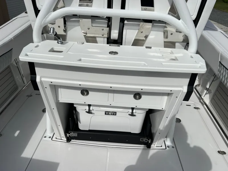Slide: The Image of 2025 Blackfin 272 CC boat interior with Yeti cooler and storage compartments. - 43