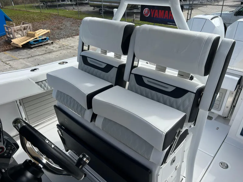 Slide: The Image of 2025 Blackfin 272 CC boat interior with dual white cushioned seats. - 49