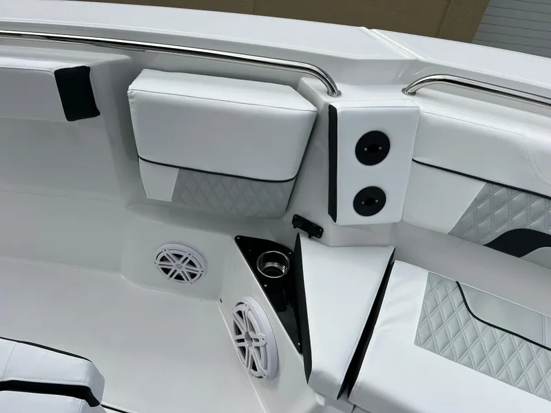 Slide: The Image of 2025 Blackfin 272 CC boat interior with white seating and speakers. - 6