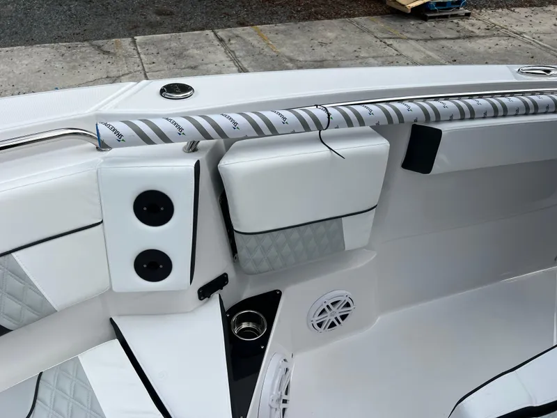 Slide: The Image of 2025 Blackfin 272 CC boat interior with white seating and speaker system. - 7