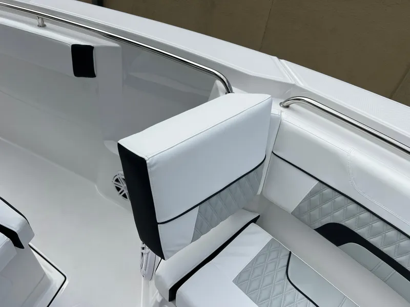 Slide: The Image of 2025 Blackfin 272 CC boat interior with white cushioned seating and sleek design. - 8
