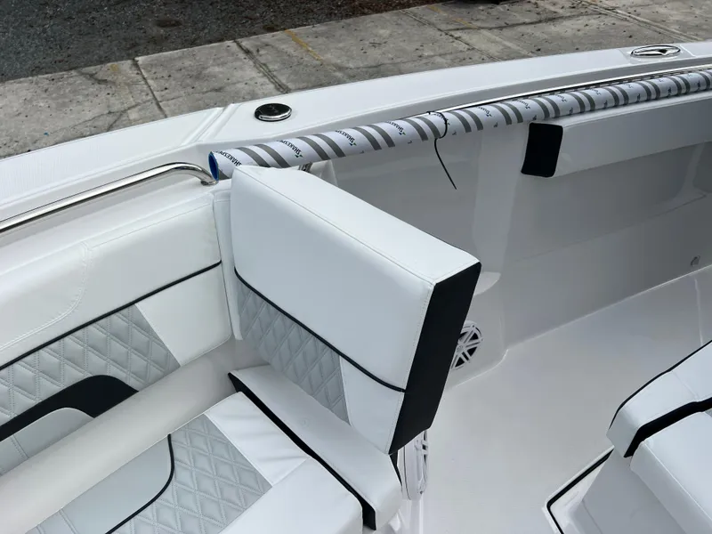 Slide: The Image of 2025 Blackfin 272 CC boat interior with white cushioned seating and diamond stitching. - 9