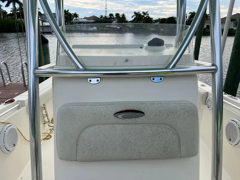 Slide: The Image of 2015 Cobia 237 Center Console boat interior with steering console and railing. - 11