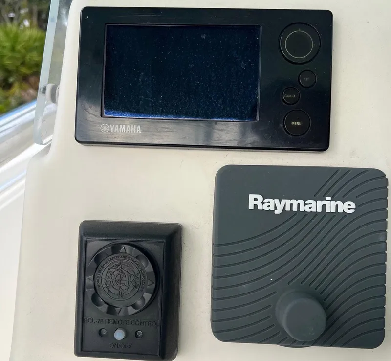 Slide: The Image of Yamaha and Raymarine controls on 2015 Cobia 237 Center Console boat dashboard. - 14