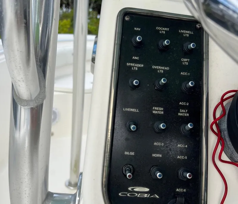 Slide: The Image of Control panel of a 2015 Cobia 237 Center Console boat. - 15