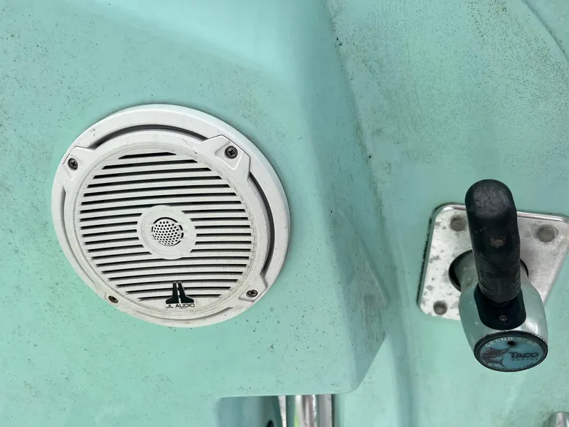 Slide: The Image of Close-up of a 2015 Cobia 237 Center Console boat speaker and control lever. - 18