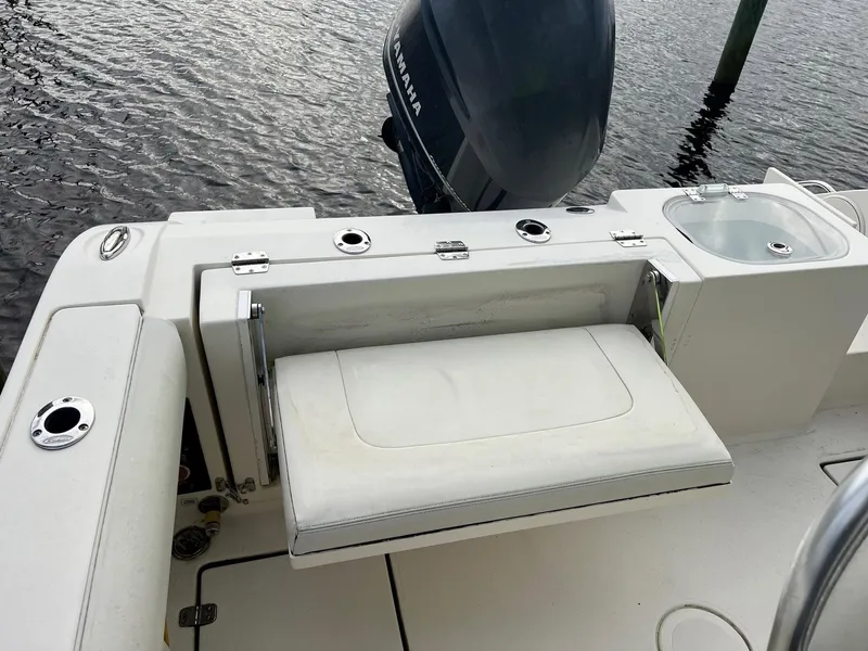 Slide: The Image of 2015 Cobia 237 Center Console boat with Yamaha engine, foldable seat, and fishing rod holders. - 20