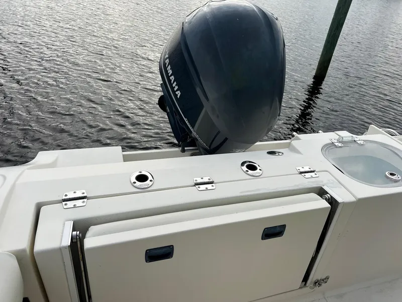 Slide: The Image of 2015 Cobia 237 Center Console boat with Yamaha outboard engine on water. - 21