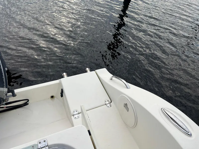 Slide: The Image of 2015 Cobia 237 Center Console boat on water, rear deck view. - 23