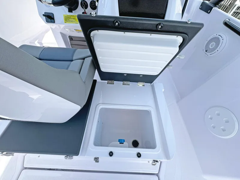 Slide: The Image of 2025 Axopar 25 Cross Top boat interior with open storage compartment. - 8