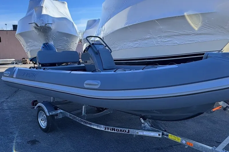 The Image of 2025 Highfield Classic 460 boat on trailer, parked outdoors. - 0