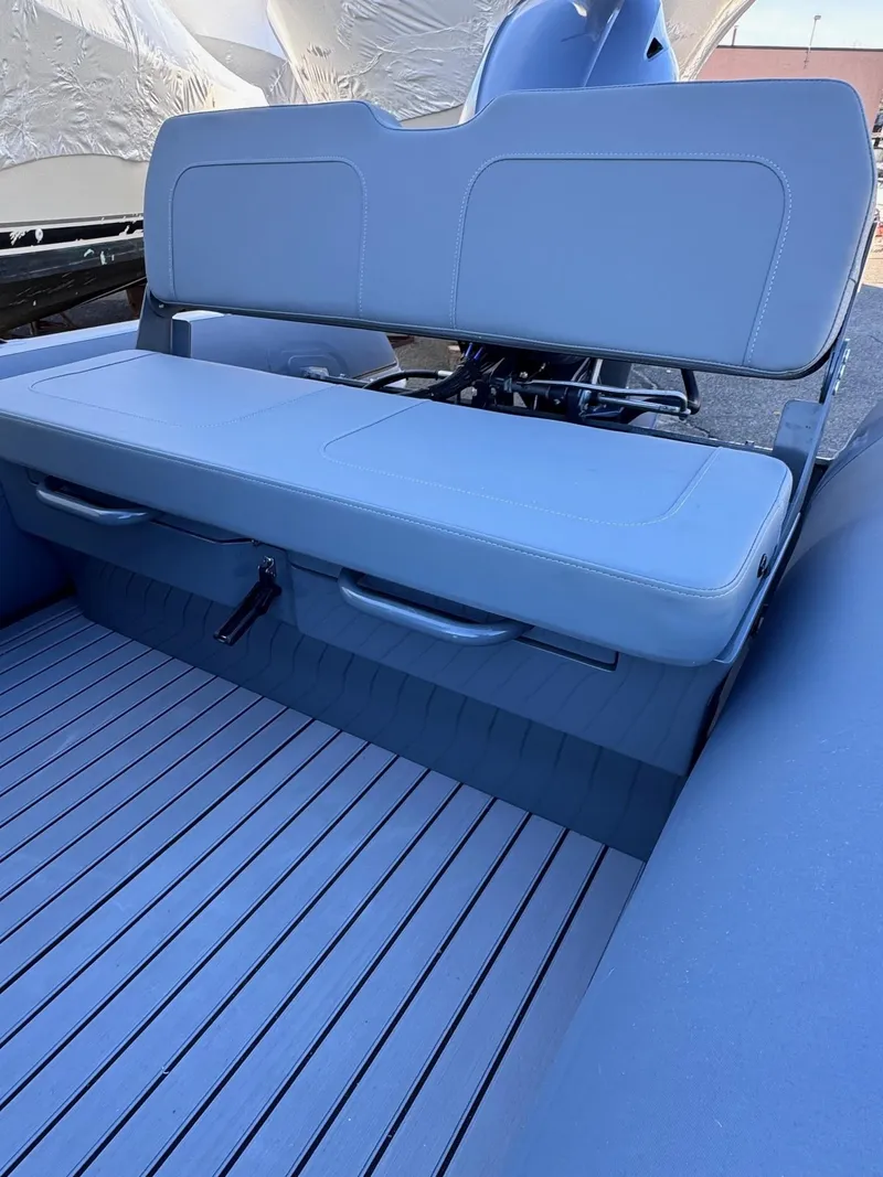 Slide: The Image of 2025 Highfield Classic 460 boat interior with blue cushioned seating. - 3