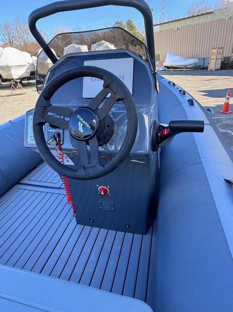 Slide: The Image of Highfield Classic 460 boat interior, 2025 model, featuring steering console and seating. - 5