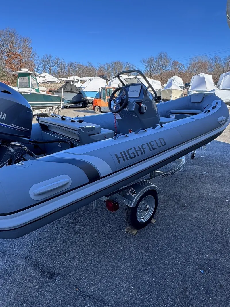 Slide: The Image of 2025 Highfield Classic 460 boat on trailer, parked outdoors. - 7