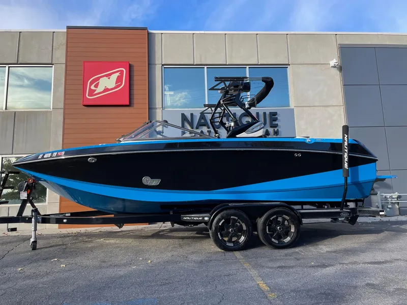 Slide: The Image of 2015 Nautique Super Air G23 boat in blue and black on trailer. - 1