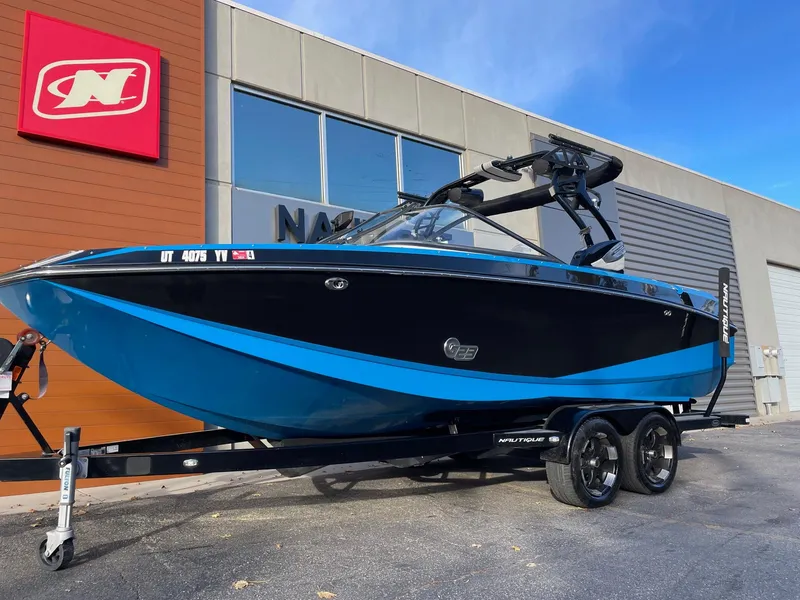 Slide: The Image of 2015 Nautique Super Air G23 boat on trailer, parked outside dealership. - 2