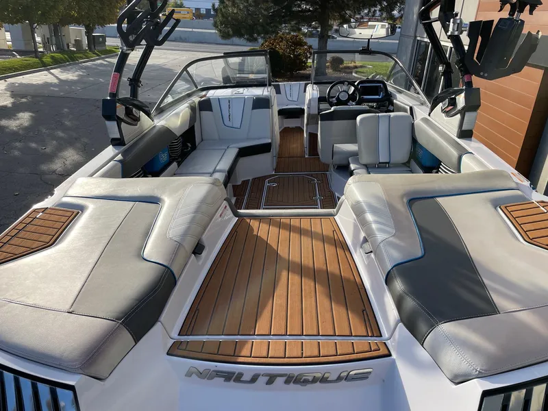 Slide: The Image of 2015 Nautique Super Air G23 boat interior with luxurious seating and teak flooring. - 4