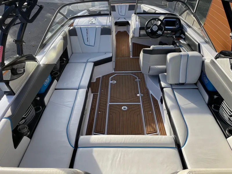 Slide: The Image of Interior of 2015 Nautique Super Air G23 boat with luxurious seating and sleek design. - 5