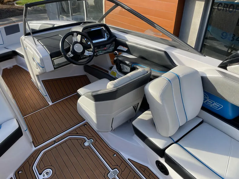 Slide: The Image of 2015 Nautique Super Air G23 boat interior with modern dashboard and seating. - 6