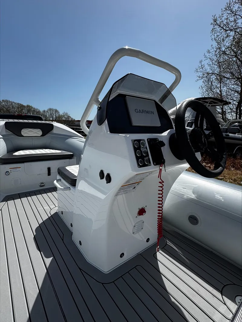 Slide: The Image of 2025 Highfield Sport 420 boat cockpit with steering wheel and control panel. - 11
