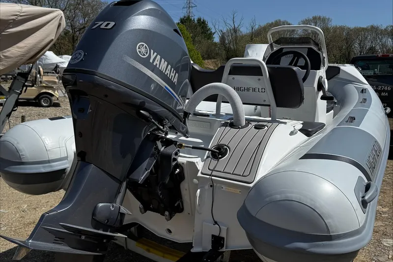 Slide: The Image of 2025 Highfield Sport 420 inflatable boat with Yamaha outboard motor, docked outdoors. - 19